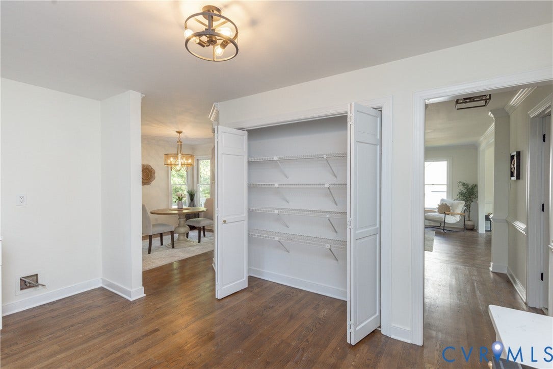 Hardwood flooring throughout, recessed lighting, and a pantry with bi-fold doors and wire shelving