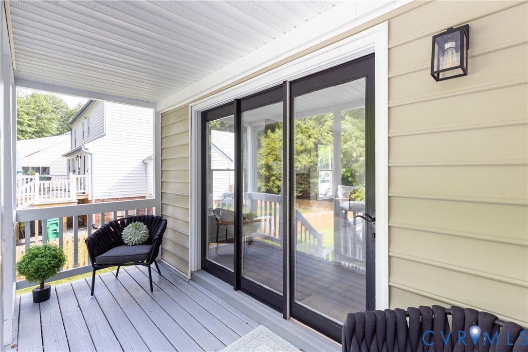 Covered porch with painted wood-finish flooring, white railing, and a slatted ceiling