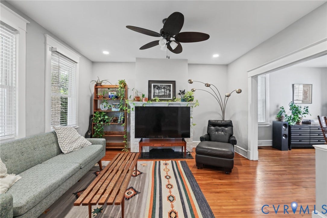 Recessed lighting, wood-finish flooring, ceiling fan, white trim work, and a fireplace with a white mantel