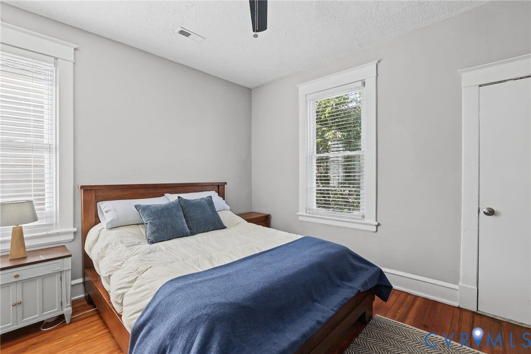 Hardwood flooring, painted walls, ceiling fan, and white trim