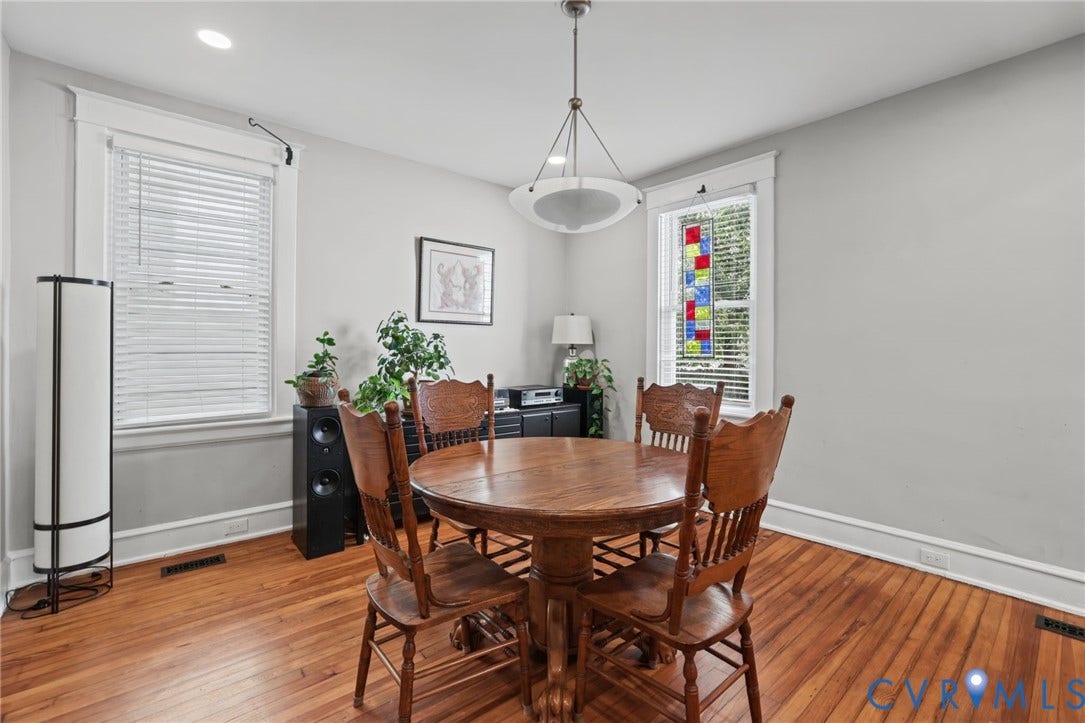 Hardwood flooring with a warm finish, recessed lighting, and a decorative stained-glass window panel
