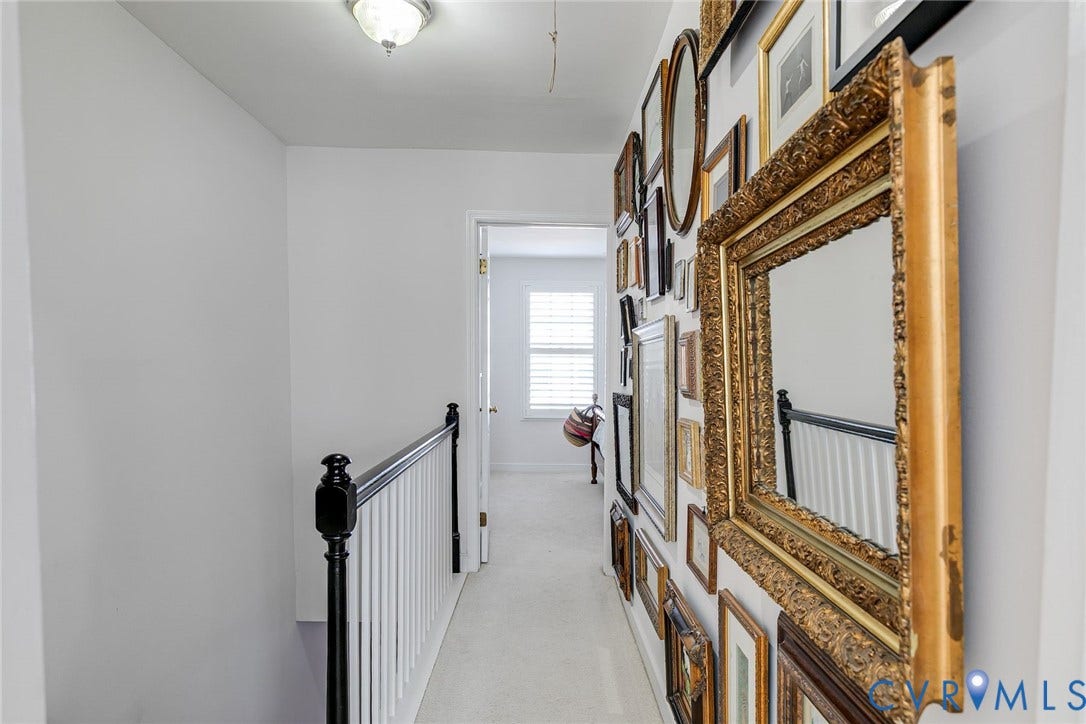 Stairwell and hallway to primary bedroom