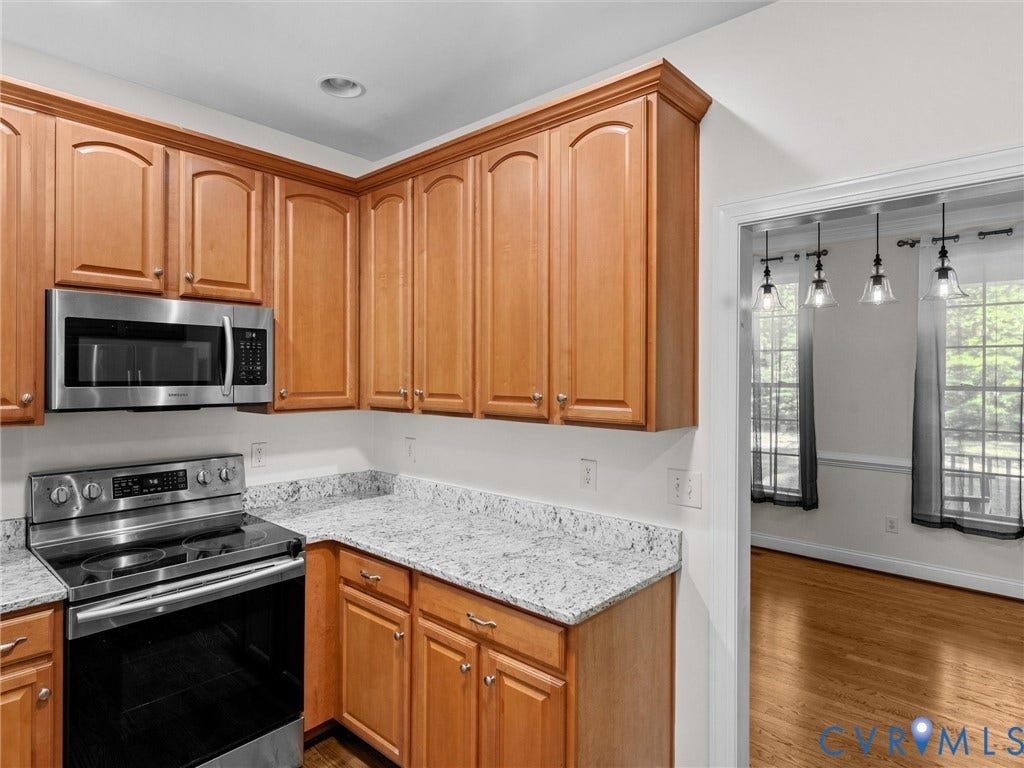 Kitchen featuring wood cabinetry, stainless steel appliances, and light-toned countertops