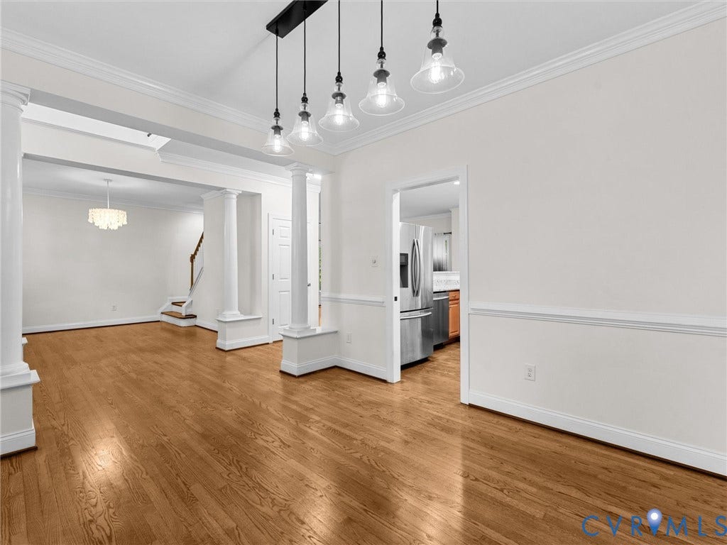 Hardwood flooring, recessed lighting, crown molding, chair rail, and modern pendant lighting