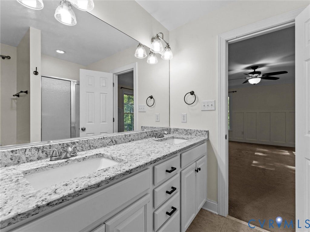 Double vanity with undermount sinks and light-toned countertops