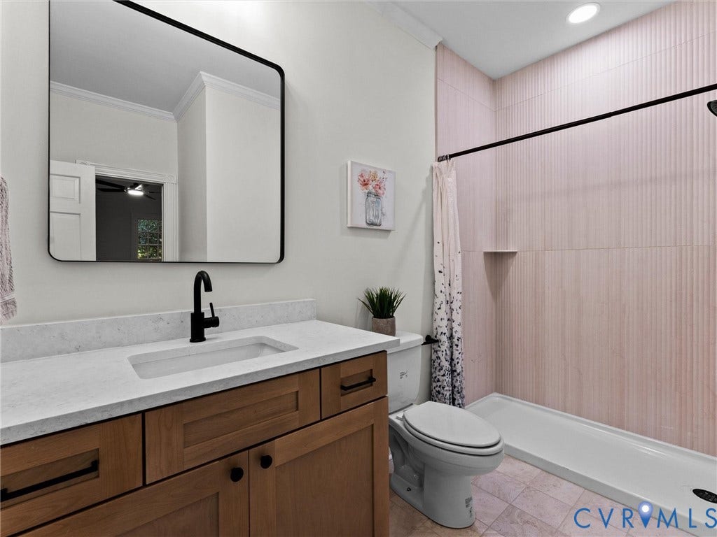 Wood-finish vanity with a white countertop and integrated sink