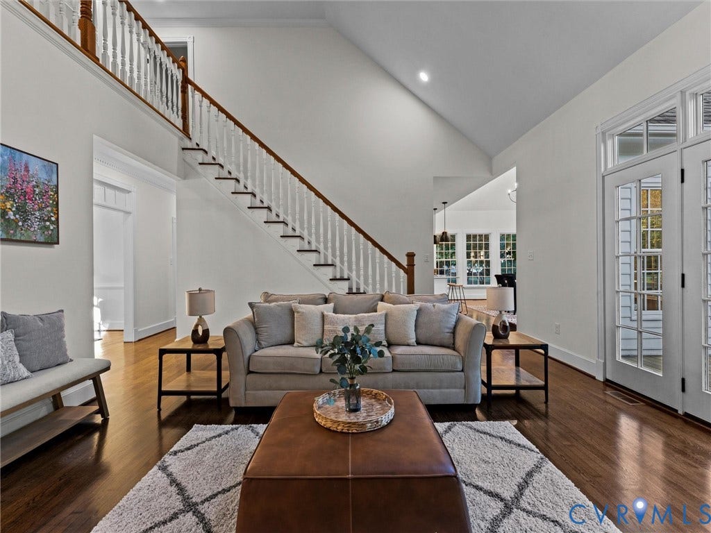 Vaulted ceilings enhance the bright living area with rich wood-finish flooring