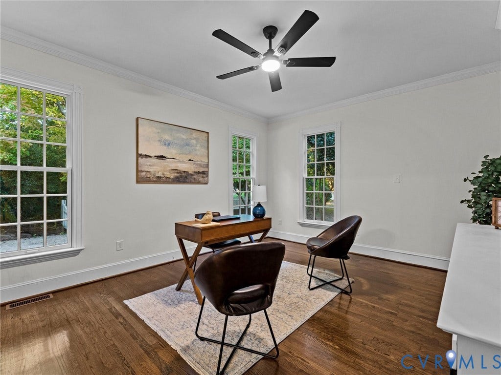 Hardwood flooring, crown molding, double-hung windows with grilles, ceiling fan with integrated lighting, and white walls