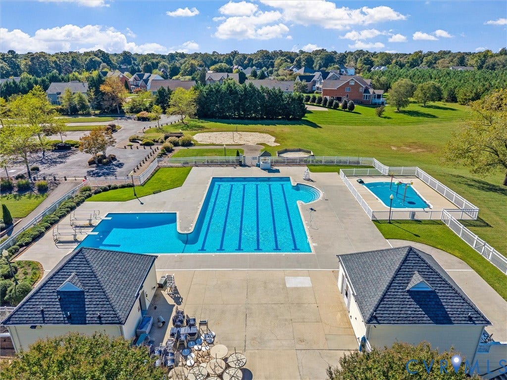 Community swimming complex featuring a lap pool, secondary pool, and surrounding green spaces