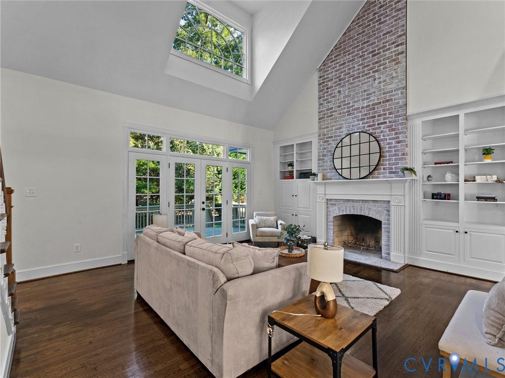 Soaring vaulted ceilings with an arched transom window
