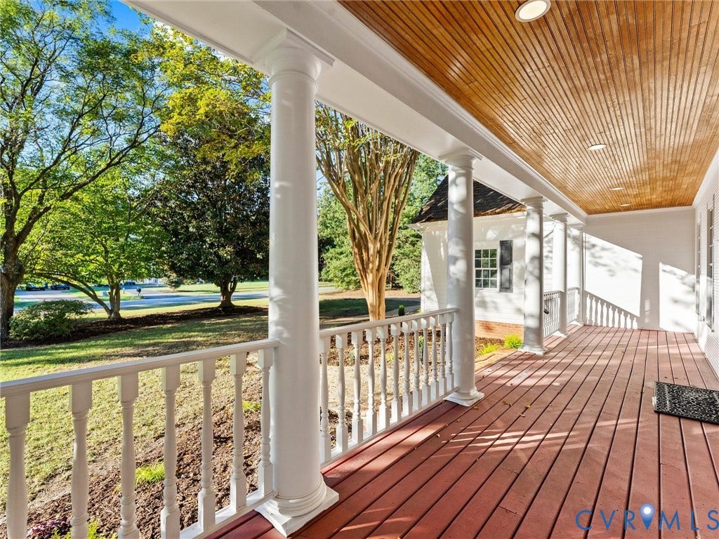 Expansive porch featuring wood-finish flooring, white balusters, and a wood-paneled ceiling with recessed lighting