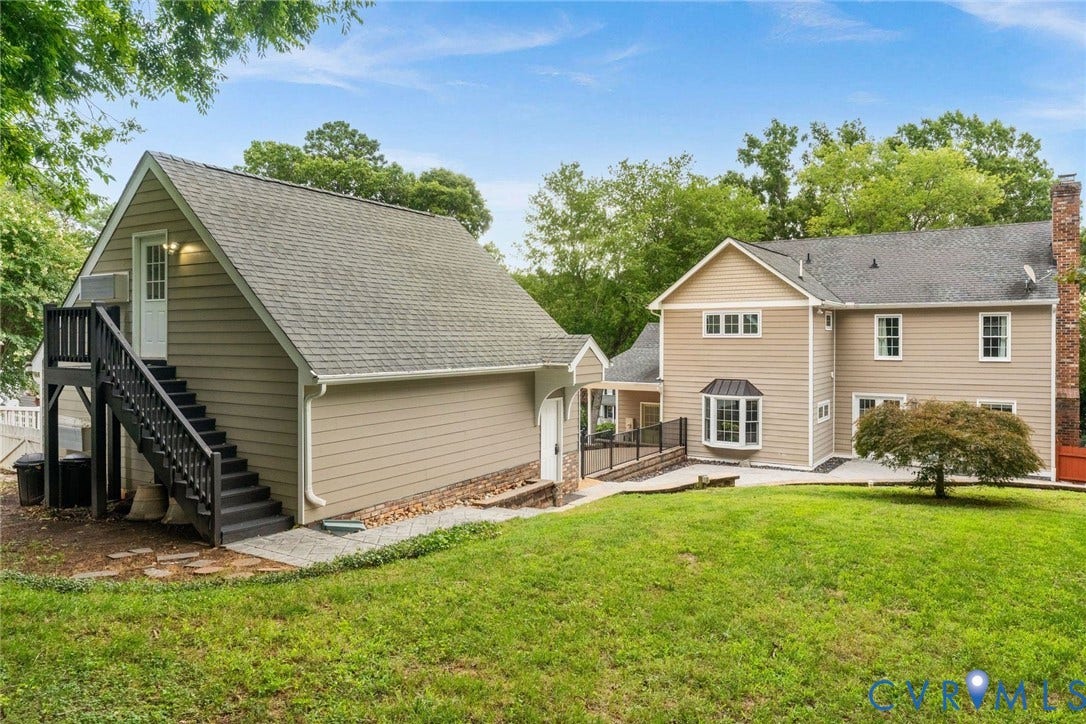 606 Westham Woods Drive, Tuckahoe, Henrico, VA 23229 Expansive exterior featuring a separate accessory dwelling unit with an exterior staircase, a bay window, a brick chimney, and a stone patio