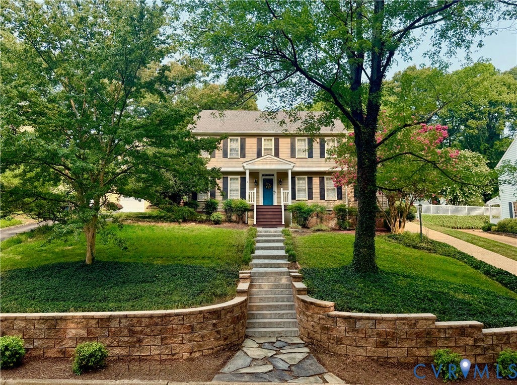 606 Westham Woods Drive, Tuckahoe, Henrico, VA 23229 Traditional-style home featuring a covered entry, shuttered windows, and a multi-level landscape with a stone retaining wall