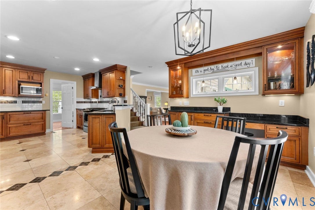 606 Westham Woods Drive, Tuckahoe, Henrico, VA 23229 Kitchen featuring rich wood cabinetry, dark countertops, and patterned floor tile