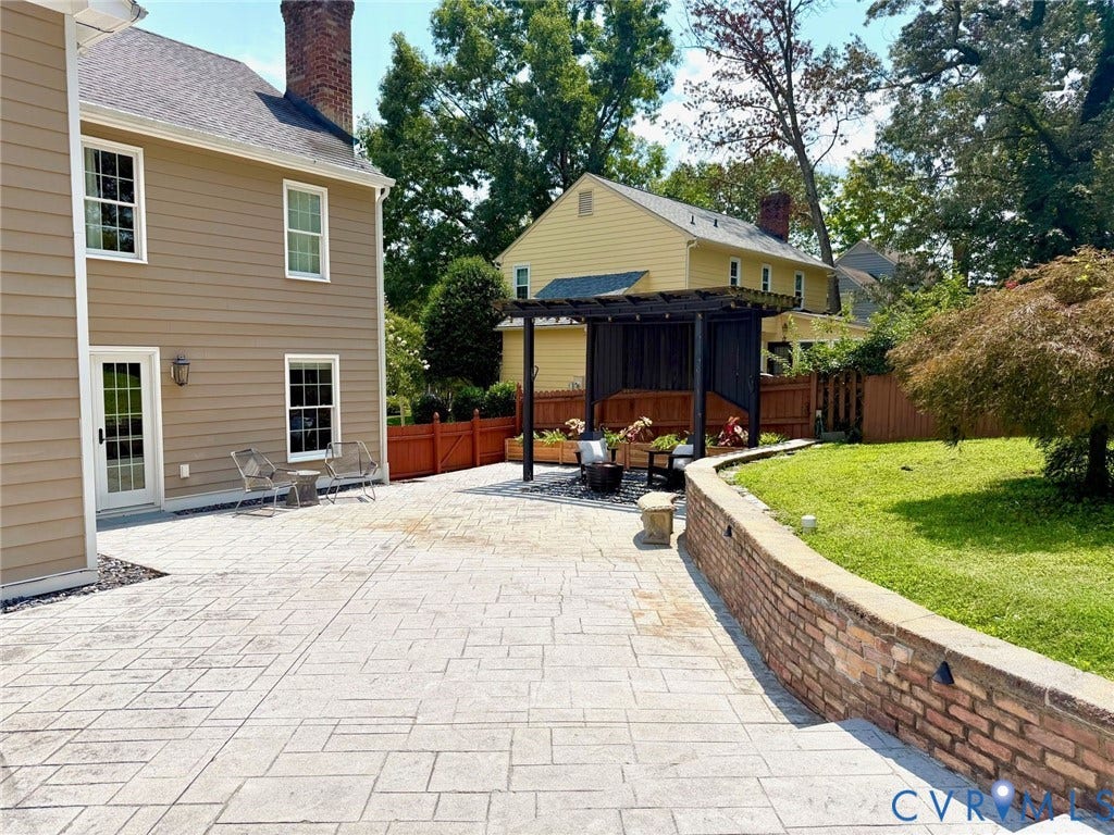 606 Westham Woods Drive, Tuckahoe, Henrico, VA 23229 Expansive patio with a retaining wall, pergola, and direct access from the property