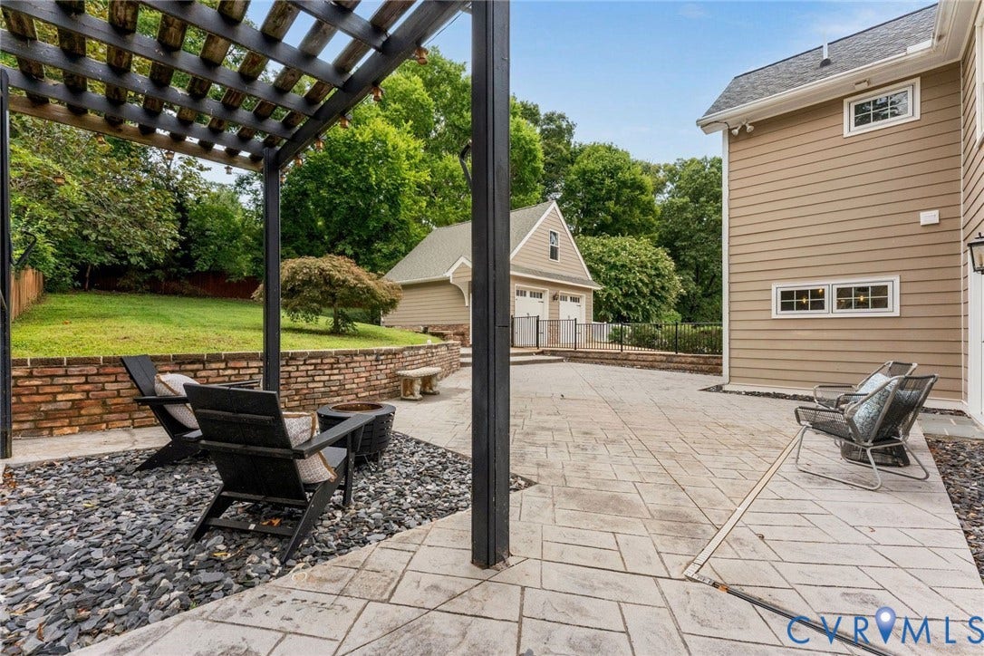 606 Westham Woods Drive, Tuckahoe, Henrico, VA 23229 Expansive patio with a black pergola and decorative rock landscaping
