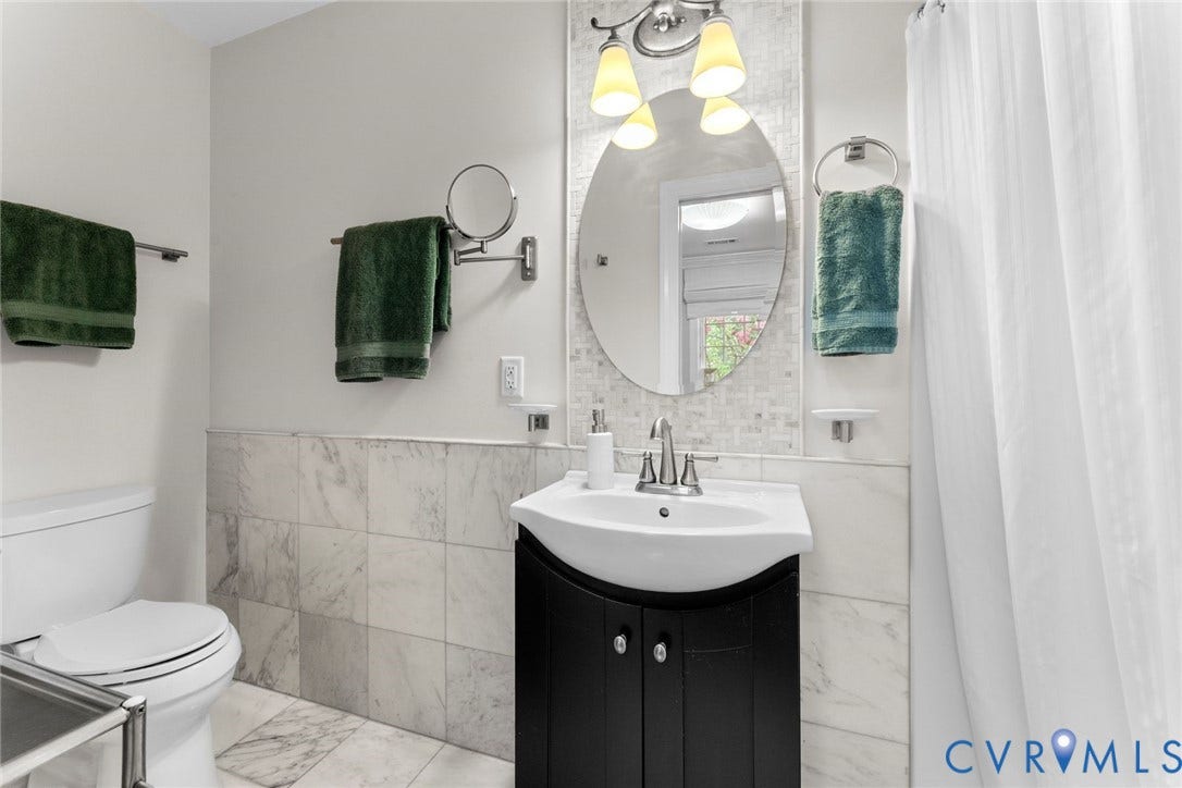 606 Westham Woods Drive, Tuckahoe, Henrico, VA 23229 Black vanity with integrated sink, chrome faucet, and overhead vanity lighting