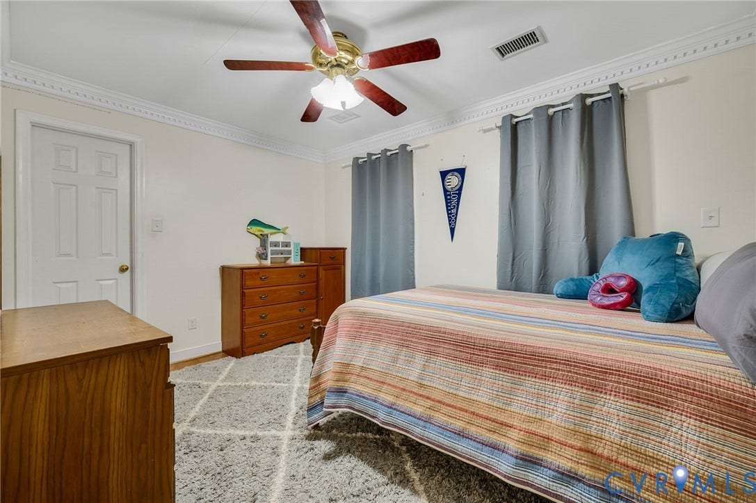 Crown molding detail, ceiling fan with light fixture, wood-finish flooring