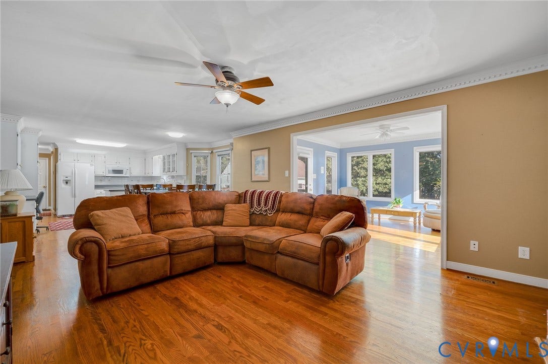 Hardwood flooring, recessed lighting, ceiling fan, crown molding, and an open concept layout