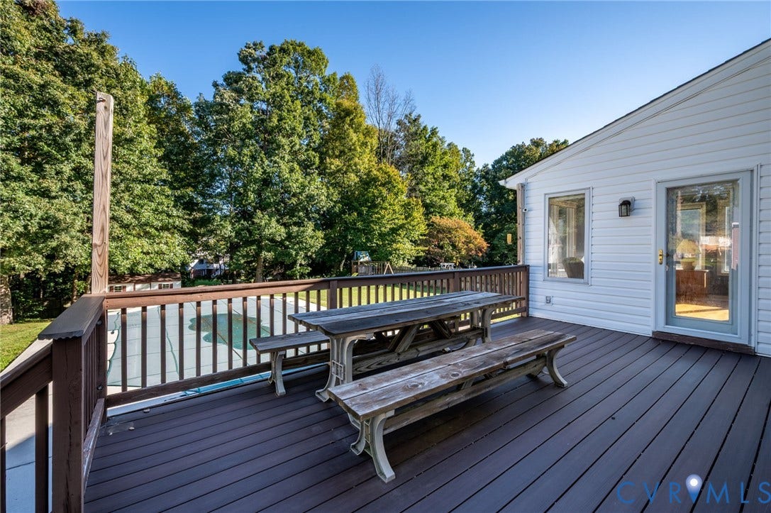 Expansive deck with composite decking and wood railing, providing an outdoor living space