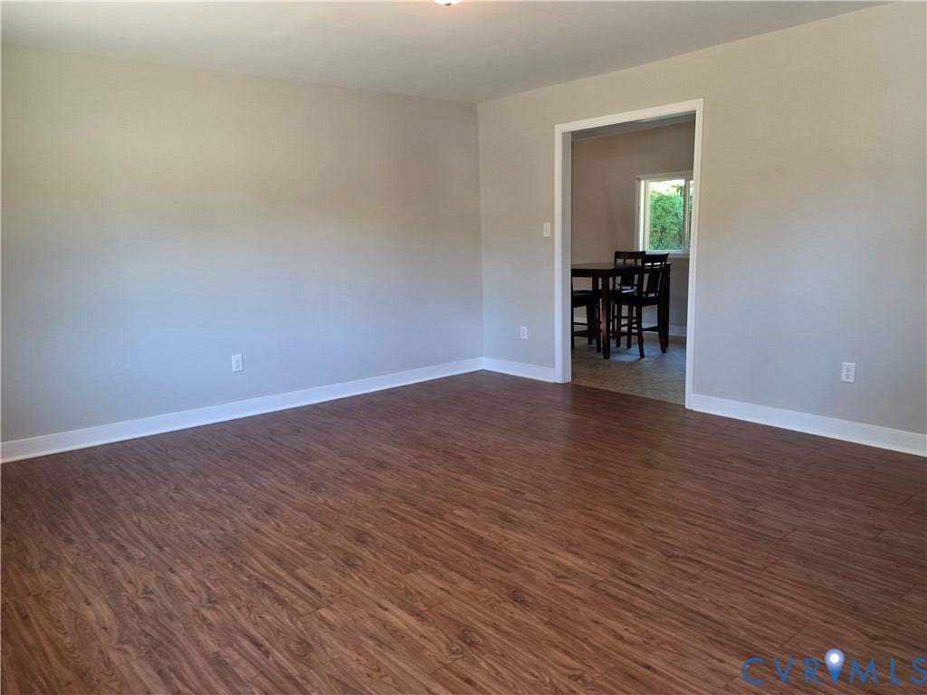 Wood-finish flooring throughout, light neutral wall paint, and white trim