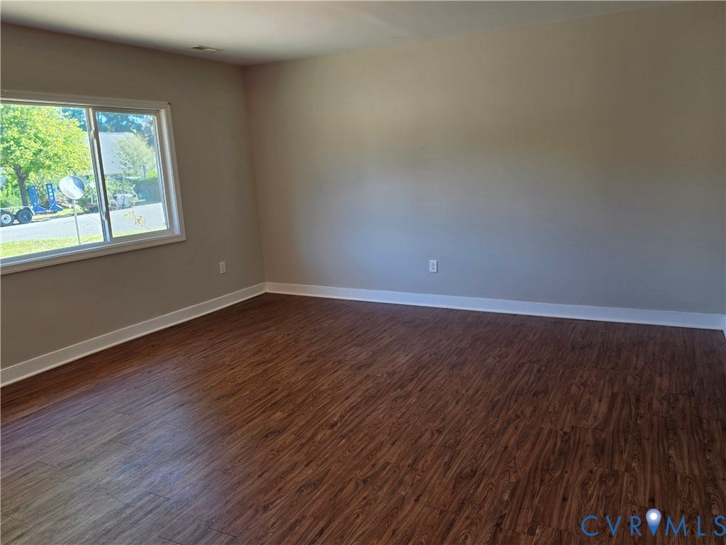 Wood-finish flooring with neutral wall tones and a white trim