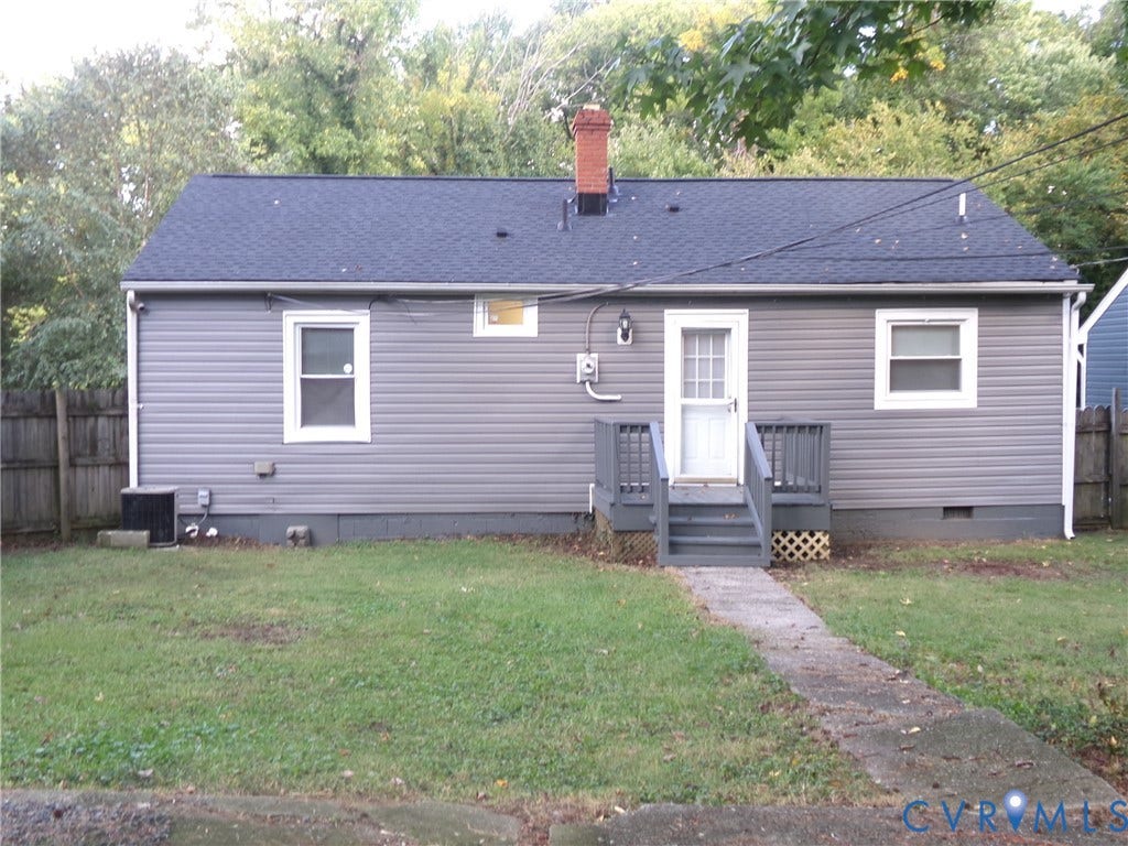 Gray vinyl siding exterior with a dark shingle roof