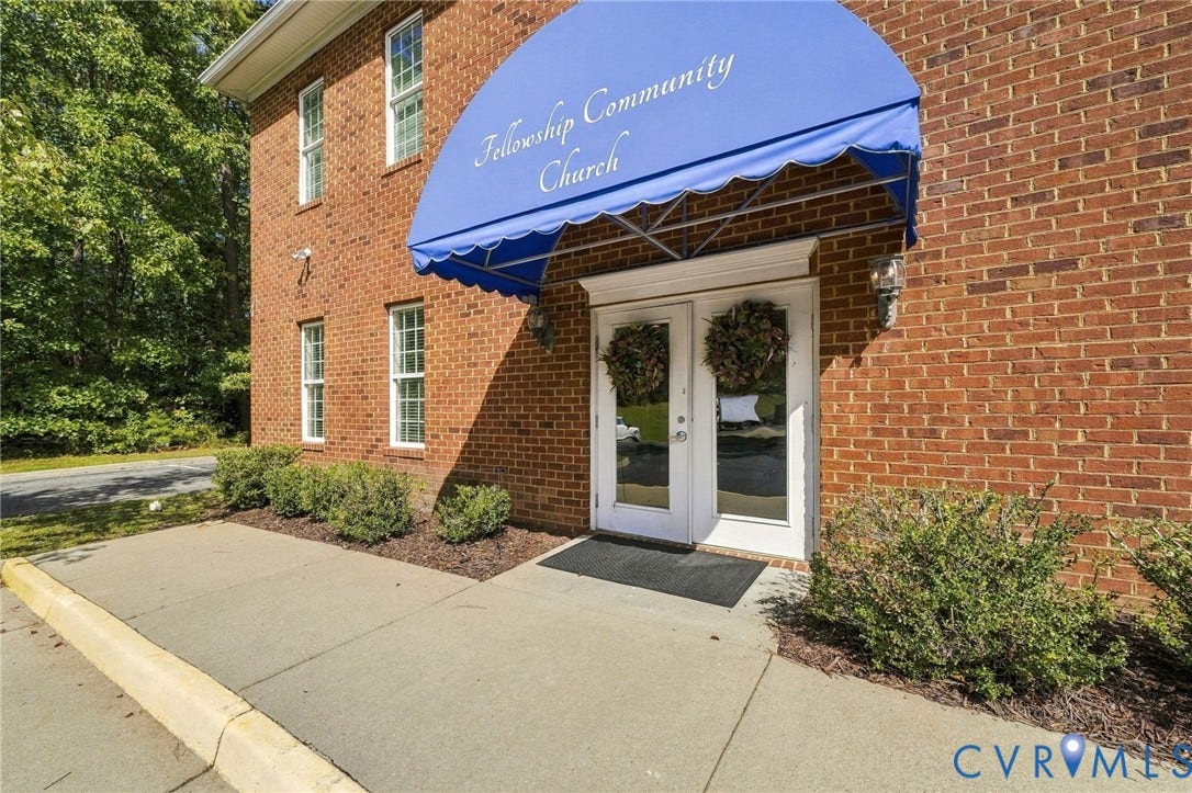 Brick facade building with a blue arched awning