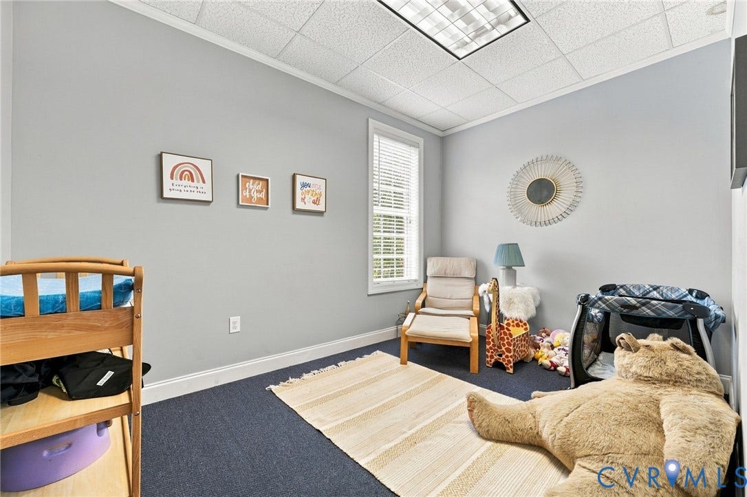 Carpeted flooring, window with blinds, and recessed lighting