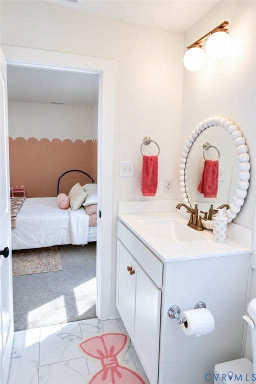 6265 Bushnell Drive, Rochambeau Estates, New Kent, VA 23124 White vanity with a single basin sink, brass-finish faucet, and a wall-mounted light fixture