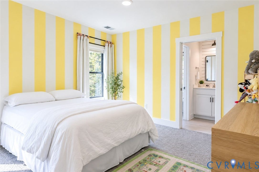 6265 Bushnell Drive, Rochambeau Estates, New Kent, VA 23124 Bedroom with striped accent wall, carpeted flooring, and a window with white curtains
