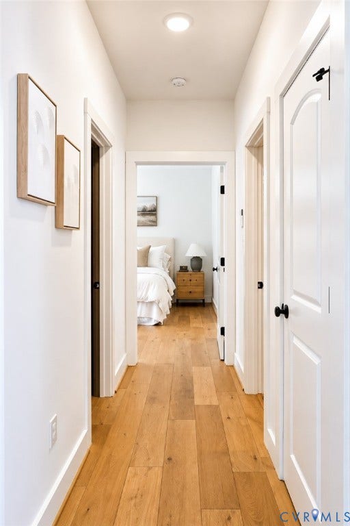 6265 Bushnell Drive, Rochambeau Estates, New Kent, VA 23124 Bright hallway showcasing warm wood-finish flooring, white painted walls, and recessed ceiling lighting