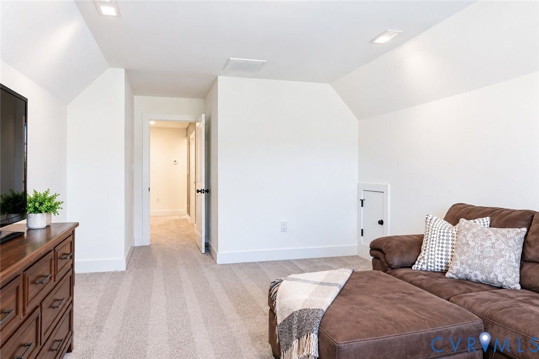 6265 Bushnell Drive, Rochambeau Estates, New Kent, VA 23124 Carpeted flooring, vaulted ceiling, recessed lighting, white trim, and a doorway with a black doorknob