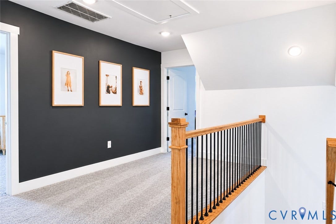 6265 Bushnell Drive, Rochambeau Estates, New Kent, VA 23124 Carpeted hallway featuring a dark accent wall, recessed lighting, and a wood and metal baluster railing