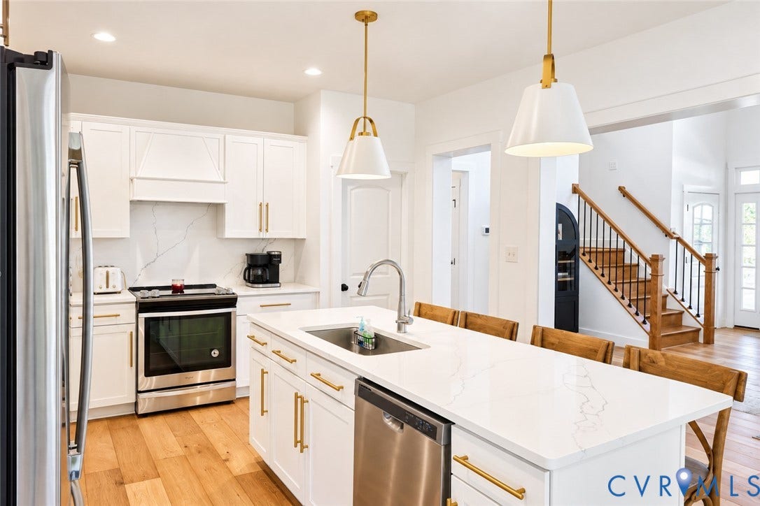 6265 Bushnell Drive, Rochambeau Estates, New Kent, VA 23124 Gourmet kitchen with white cabinetry, stainless steel appliances, and a central island with a sink