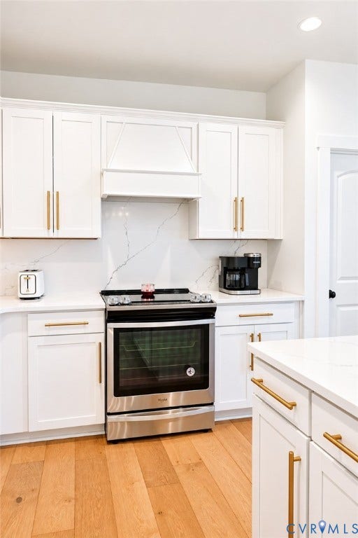 6265 Bushnell Drive, Rochambeau Estates, New Kent, VA 23124 White shaker cabinetry with gold-finish hardware, stainless steel range, white countertops, and wood-finish flooring