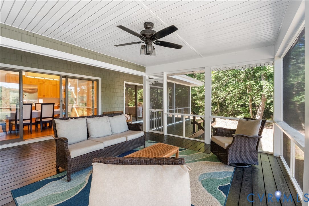 Screened porch featuring a ceiling fan, plank wood flooring, and a beadboard ceiling