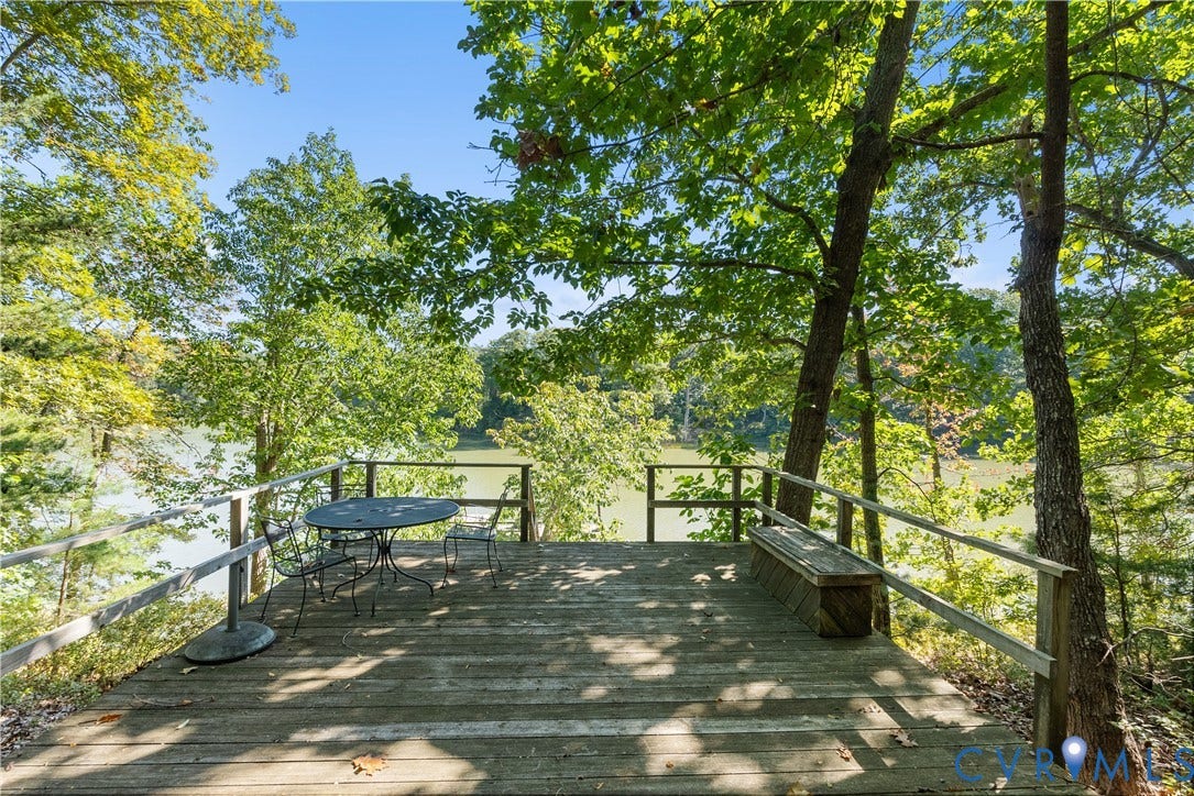 Wood deck with railing overlooking a body of water