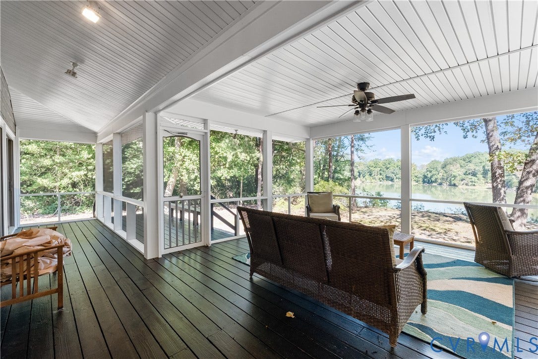 Screened porch with dark wood-finish flooring, a white paneled ceiling, and a ceiling fan
