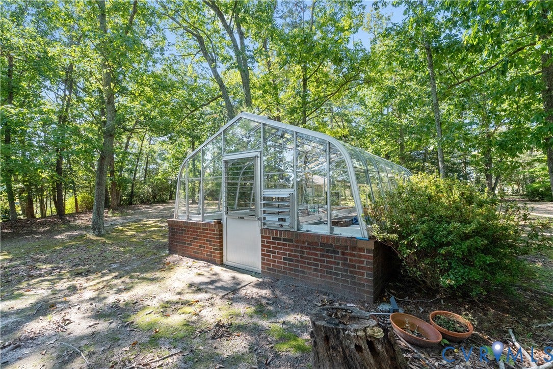 Greenhouse with a brick base and glass panels