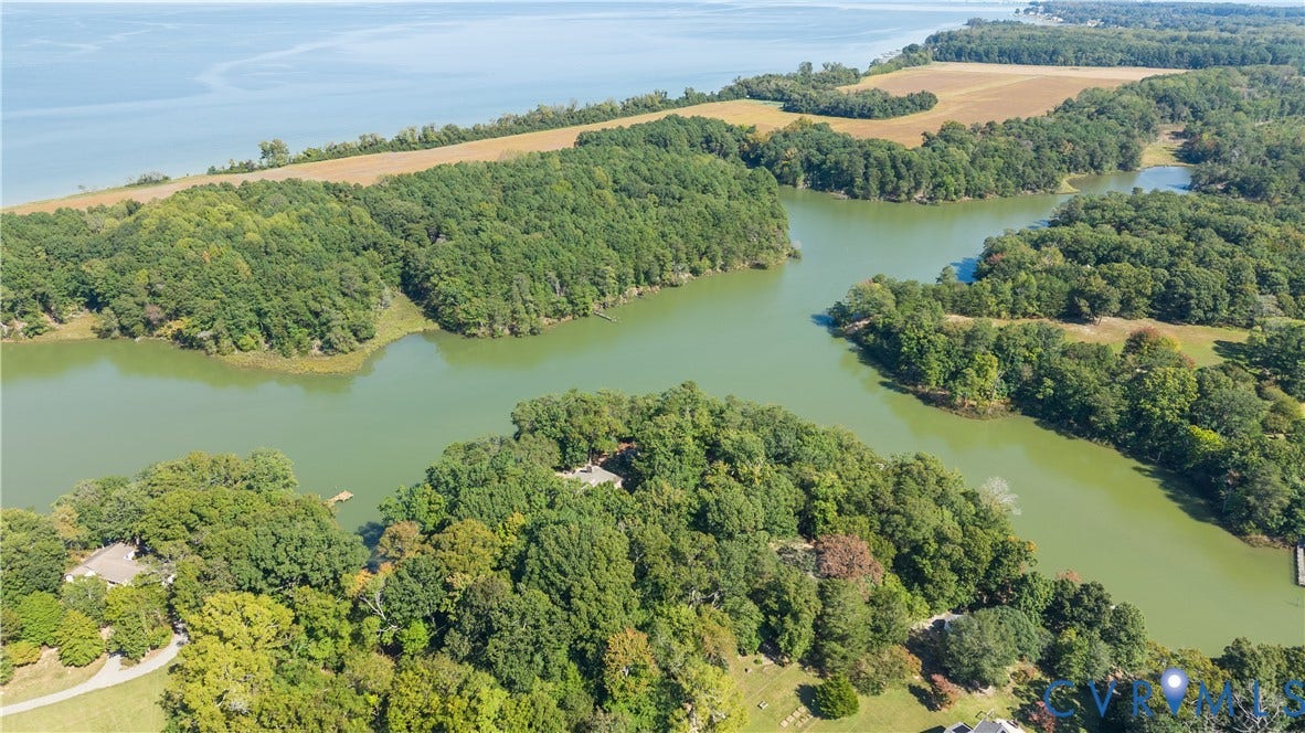 Expansive water frontage with mature tree coverage and direct water access