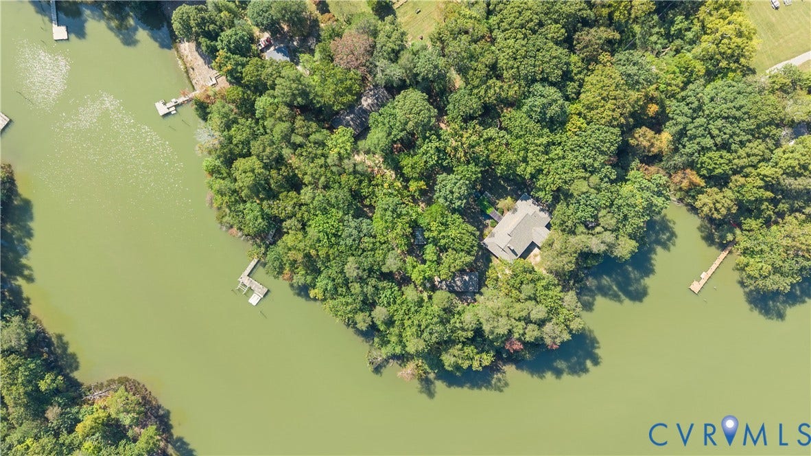 Waterfront property featuring a single-story residence with a gabled roof