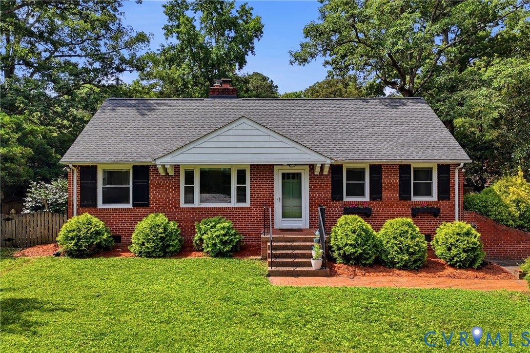 Brick exterior with a gabled roof and black shutters