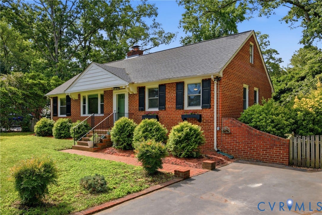 Brick exterior with a gabled roof and black shutters