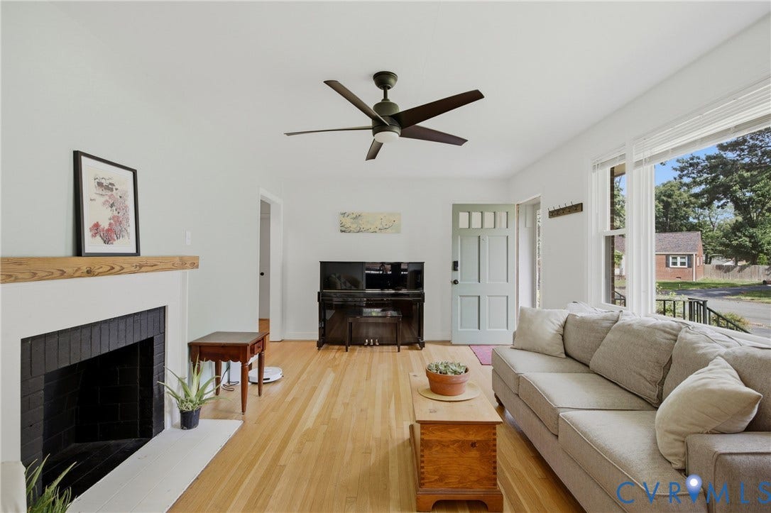 Hardwood flooring, ceiling fan, fireplace with mantle