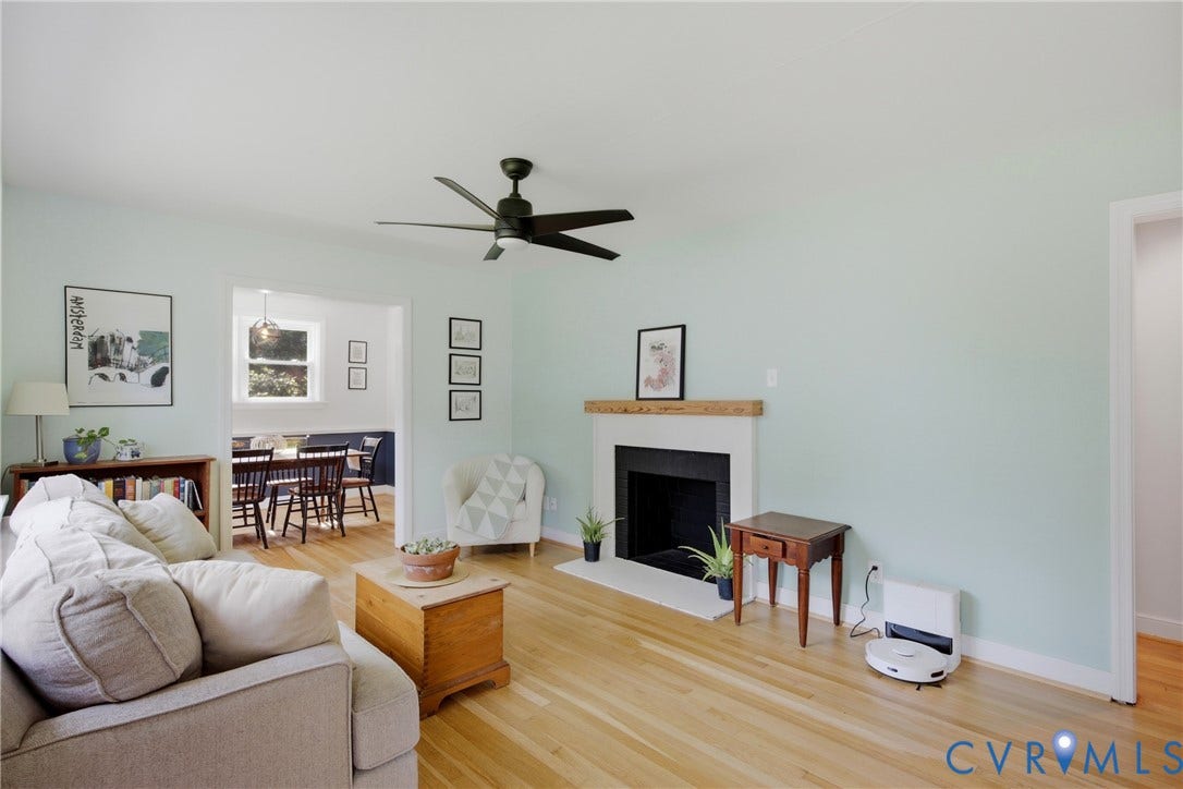 Hardwood flooring, ceiling fan, fireplace with mantle