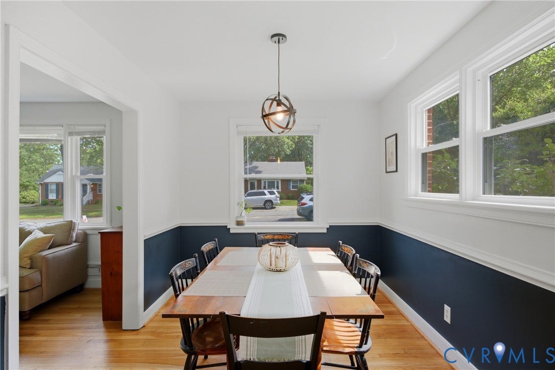 Hardwood flooring, multiple windows, and a modern light fixture