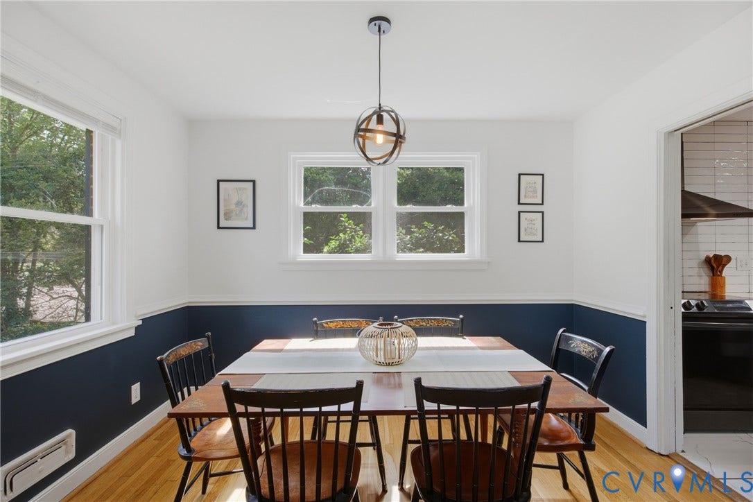Hardwood flooring, multiple windows, and a modern light fixture