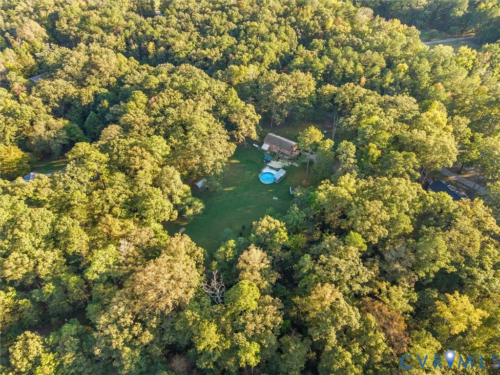8251 Old Roxbury Road, Quinton, VA 23141 Aerial perspective of a sprawling lot featuring a private swimming pool, extensive grassy grounds, and dense perimeter forestry