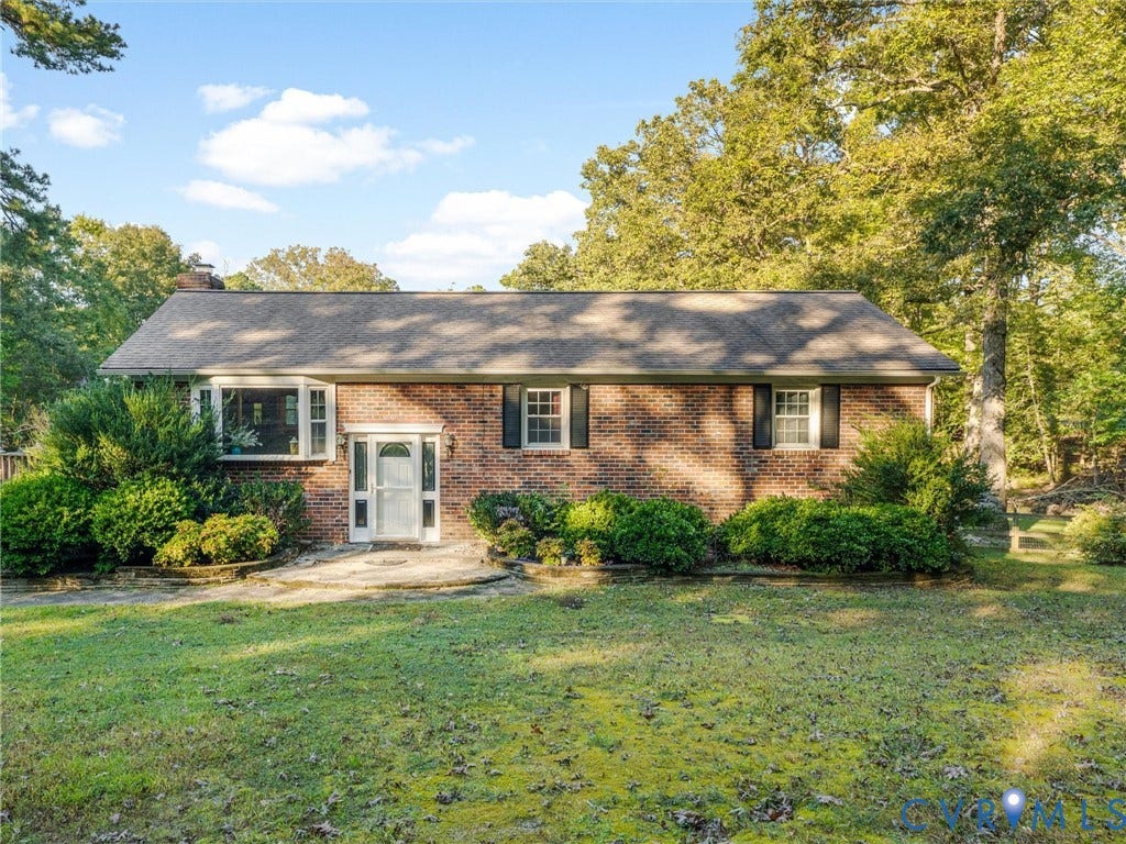 8251 Old Roxbury Road, Quinton, VA 23141 Brick exterior featuring a multi-pane bay window, shuttered windows, and a stone-paved entrance